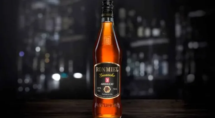 Bottle and glass of Canary Islands Ronmiel served as a traditional liqueur