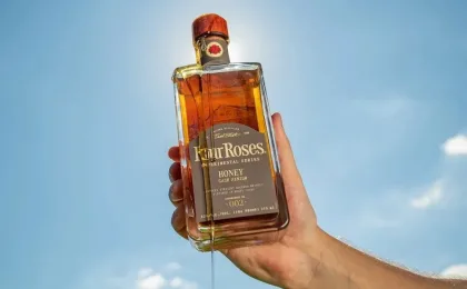 Bouteille de bourbon Four Roses aux côtés d’un miel vieilli en fût de bourbon