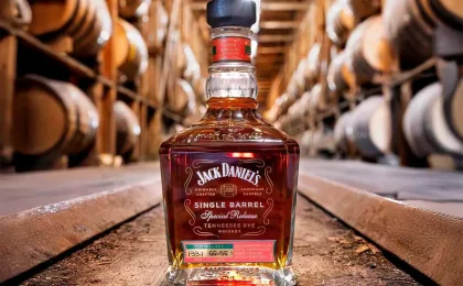 Jack Daniel’s Coy Hill rye whiskey bottle displayed on an oak barrel